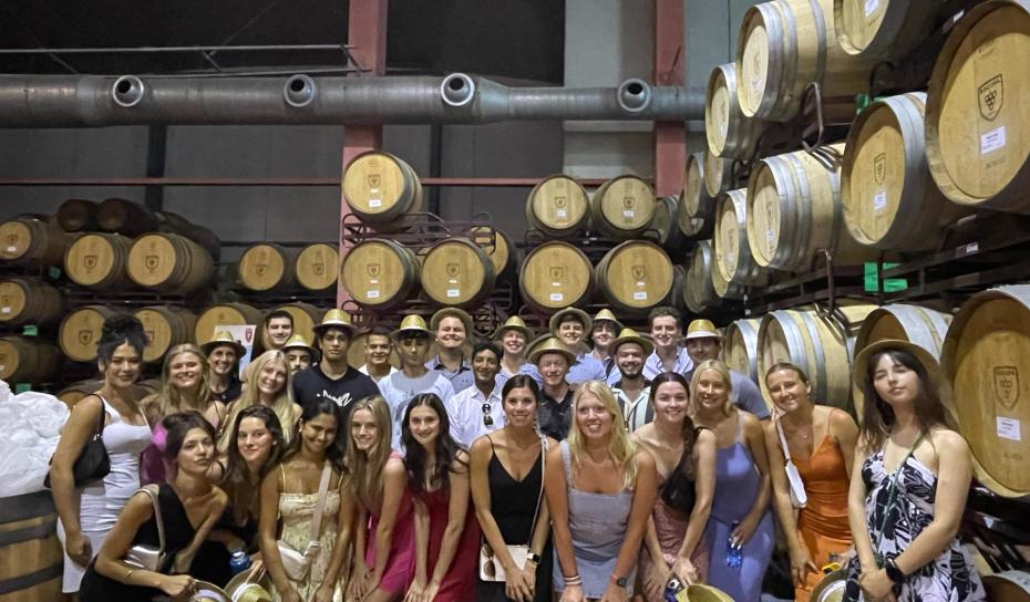 students on company visit to winery - barrel room