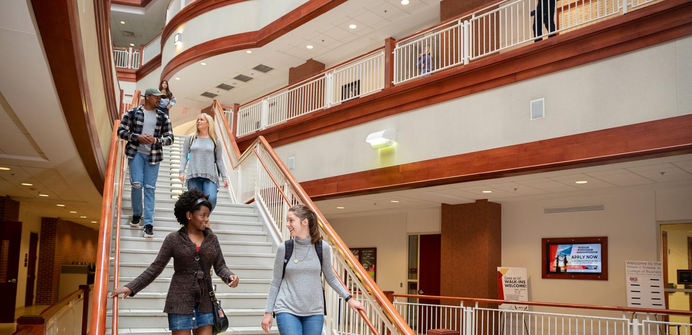 Image: Students walking down stairs in the Cornell Hall atrium