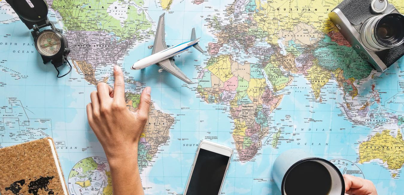 Map, coffee, camera, passport, hand, phone