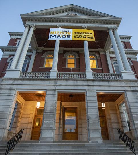 Image: Jesse Hall with a congratulatory commencement banner hanging in front.