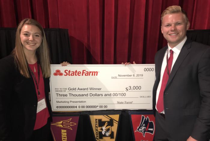 Image: Kristen Ross and Grant Garske holding a large prize check from State Farm.