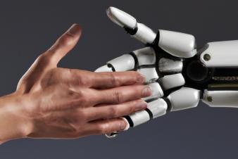 A human hand shaking hands with a robot hand