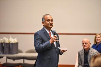 Image: Vairam Arunachalam speaking in front of audience