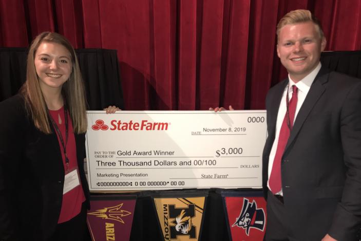 Image: Kristen Ross and Grant Garske holding a large prize check from State Farm.