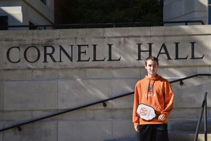 Dylan Frazier standing in front of Cornell Hall