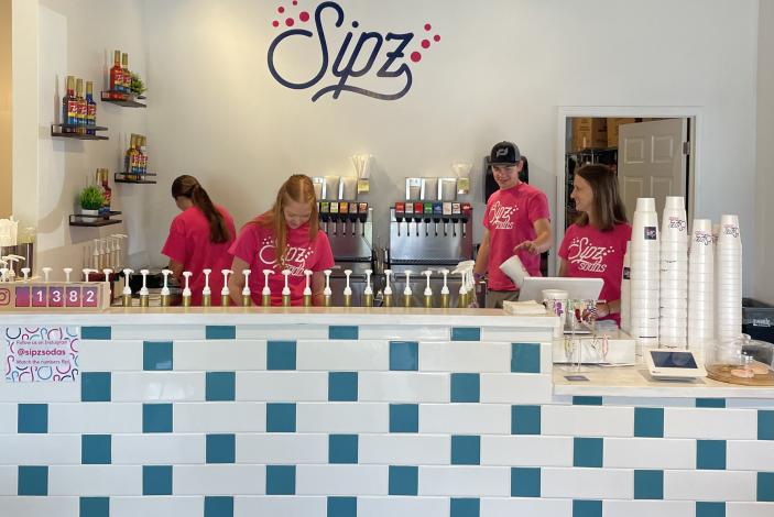 Image: students working behind a counter