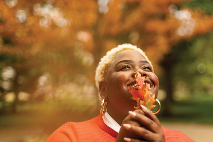 Photo of Trulaske senior S’Riyyah DeBos with fall trees in the background