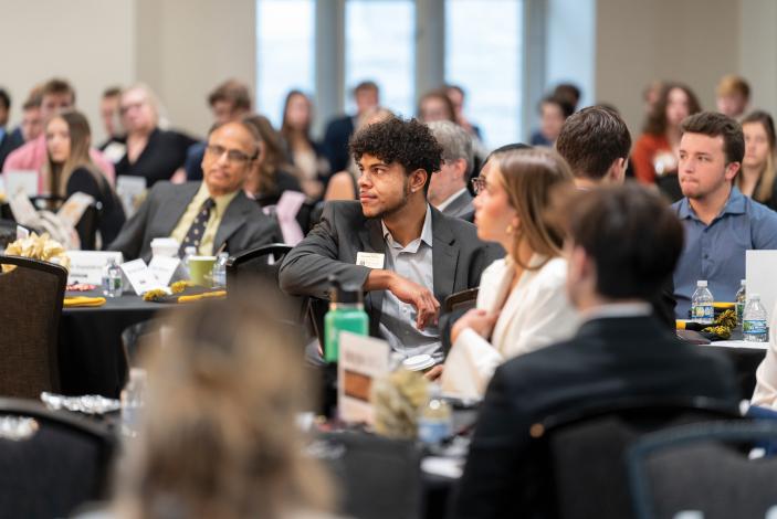 Students sitting and listening to a speaker at an edge event 