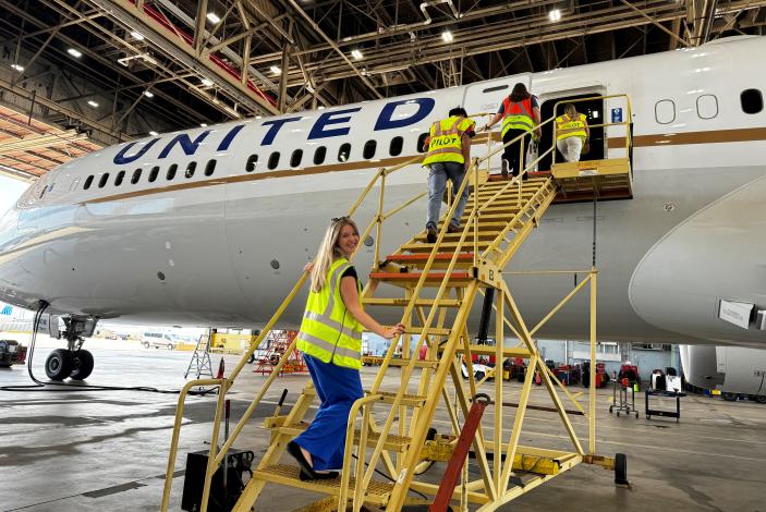 Image: Bri Zahn prepares to aboard a plane during her internship with United Airlines