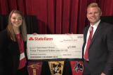 Image: Kristen Ross and Grant Garske holding a large prize check from State Farm.