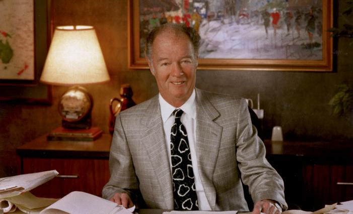 Image: Robert J. Trulaske, Sr. sitting at a desk.