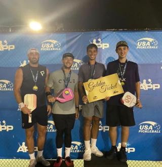 Dylan Frazier and his doubles partner, JW Johnson, hold a “golden ticket” on the medals stand at the recent Hilton Head Pickleball Open in October. 