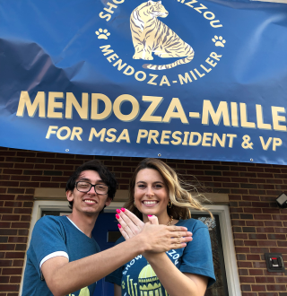 Josiah Mendoza and Molly Miller in front of one of their “Show Me Mizzou” campaign banners. 