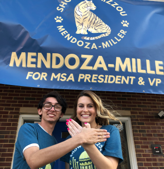 Josiah Mendoza and Molly Miller in front of one of their “Show Me Mizzou” campaign banners.