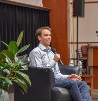 Tyler Shultz speaking in Bush Auditorium 