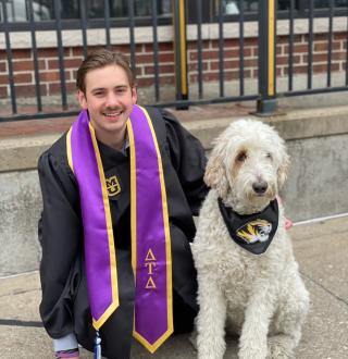 Bauer and MO snap a picture in their graduation regalia outside one of their favorite Columbia restaurants, Campus Bar & Grill.